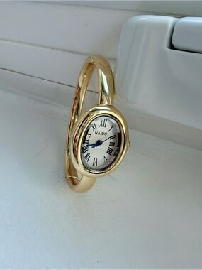 NAIDU Gold Bangle Watch with Roman Dial